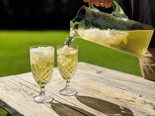 Springdrop Spritzer iced tea being poured from a pitcher into two glasses