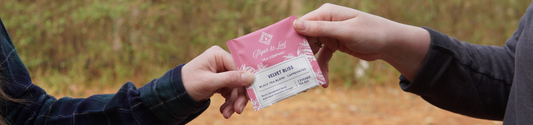 two people holding a tea bag of Piper and Leaf Seasonal Black Tea Velvet Bliss