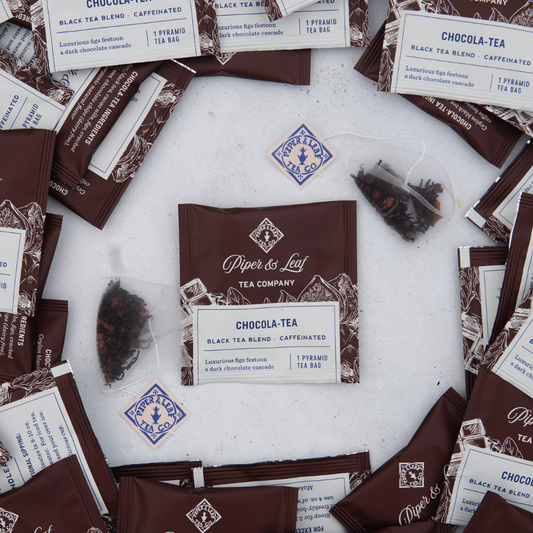 A group of brown Chocola-Tea Case of Individually Wrapped Tea Bags- 50ct with white labels by Piper & Leaf Tea Co.