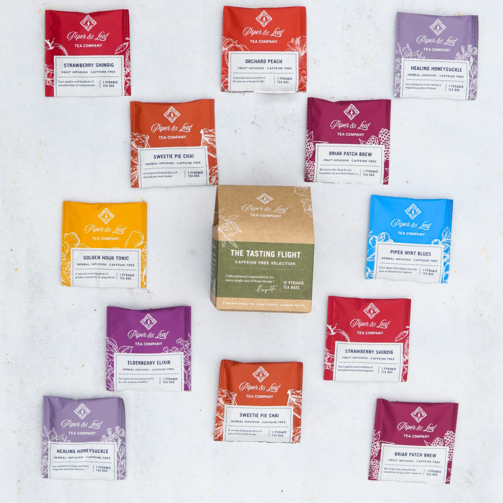 A selection of twelve vibrant tea bags from Piper & Leaf Tea Co., forming a circle around a central tasting flight packet on a white surface. These colorful packets, featuring various tea names, are ideal for those seeking caffeine-free tea options, provided in the Caffeine Free Tasting Flight - Box of 12 Tea Bags.