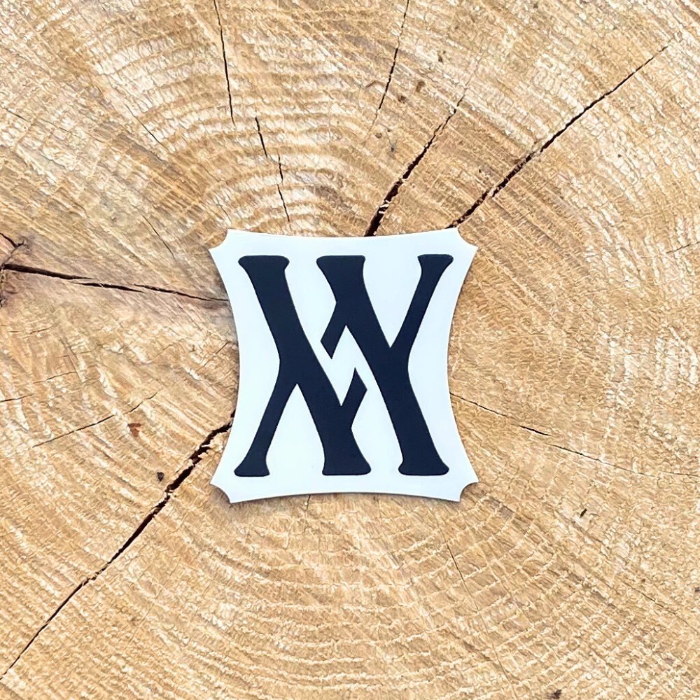 The Walling Mtn. Coffee logo on a laptop, adorned with a Walling Mtn. Sticker.