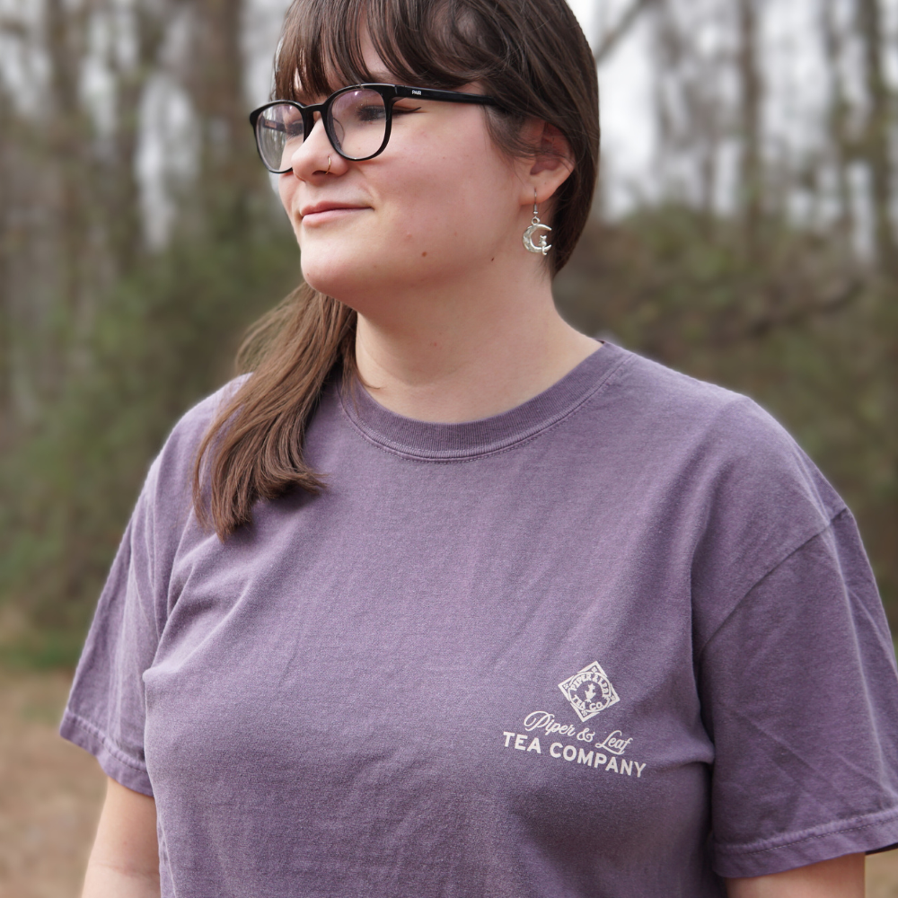 A woman wearing glasses and a Piper & Leaf Tea Co. Bouquet of Berries Short Sleeve T-Shirt.