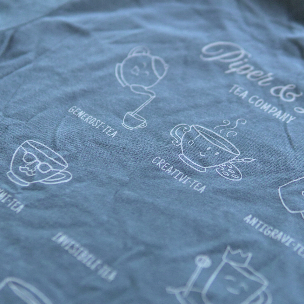 A soft short sleeve shirt with different types of Piper & Leaf Tea Co. screen printed on it.