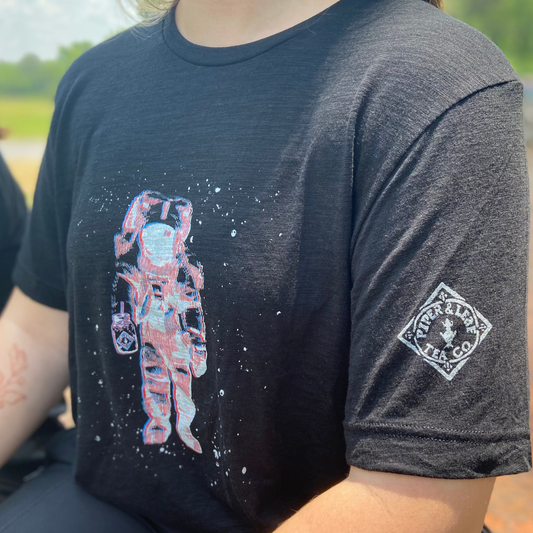 Person wearing a Piper & Leaf Tea Co. Limited Edition 3D Vision Space Man Tee with an astronaut graphic print in retro 3D effect.