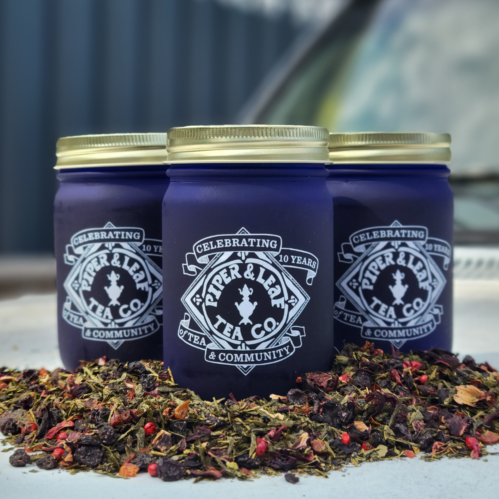three blueberry jubilee loose leaf jars surrounded by  loose tea