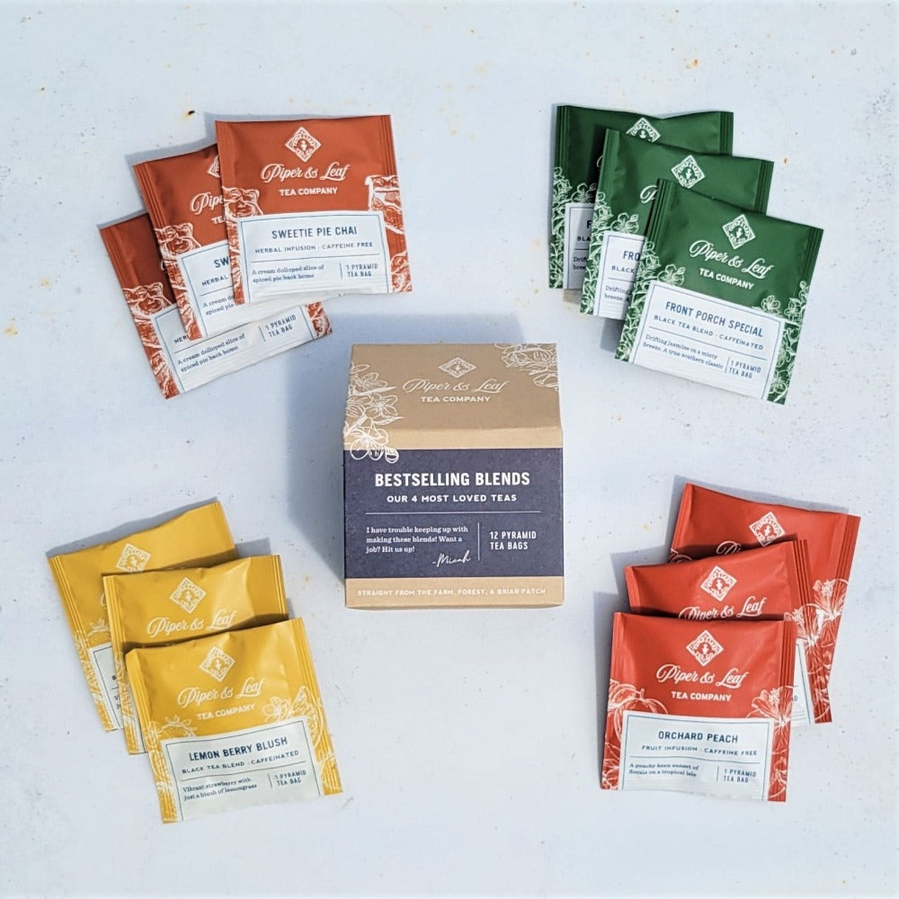 A set of assorted tea packets from Piper & Leaf Tea Co. is arranged in a circle around the "Bestselling Blends- Box of 12 Tea Bags," showcasing an array of herbal infusions and black tea blends.