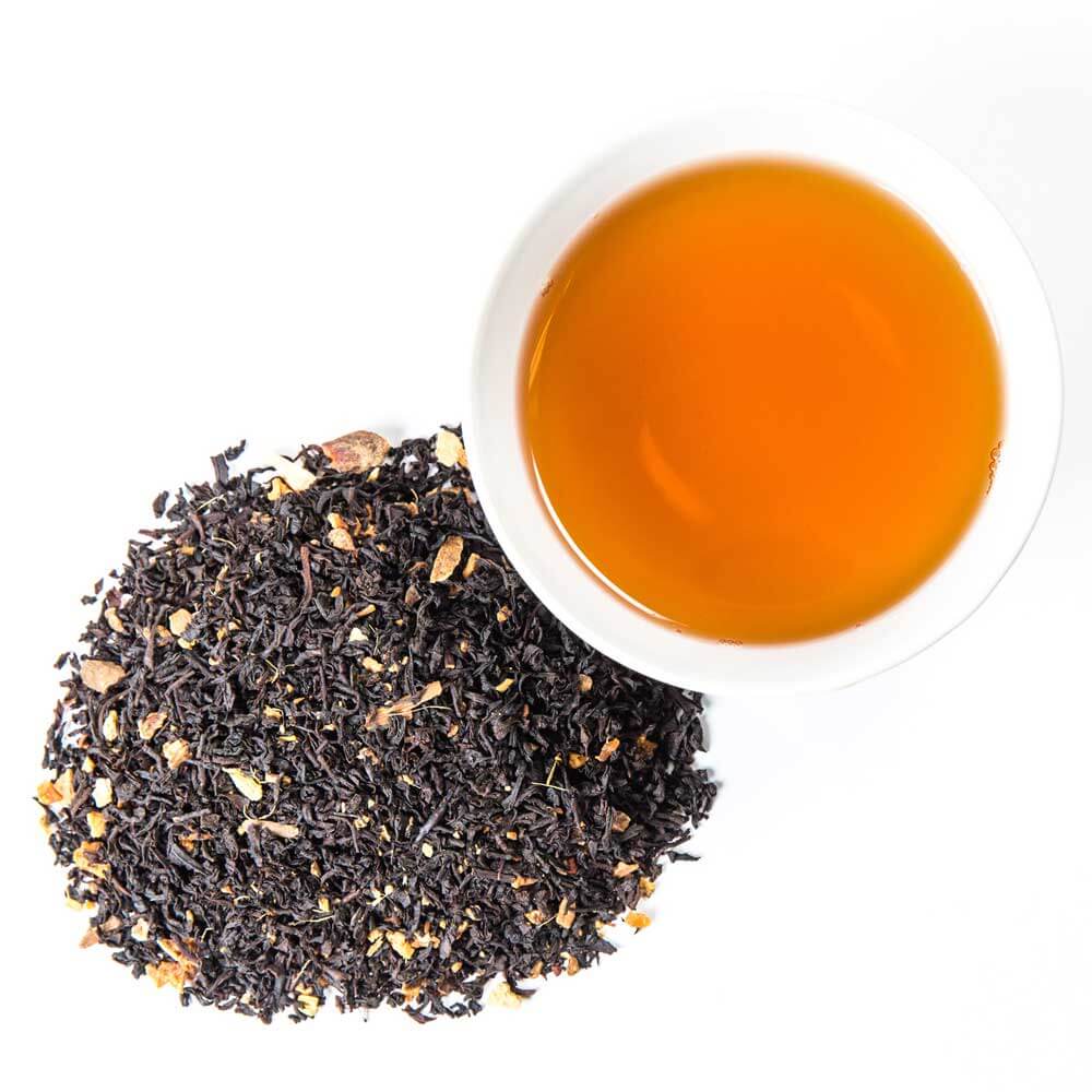 a pile of loose leaf next to a cup of brewed tea - Caramel Apple Pie