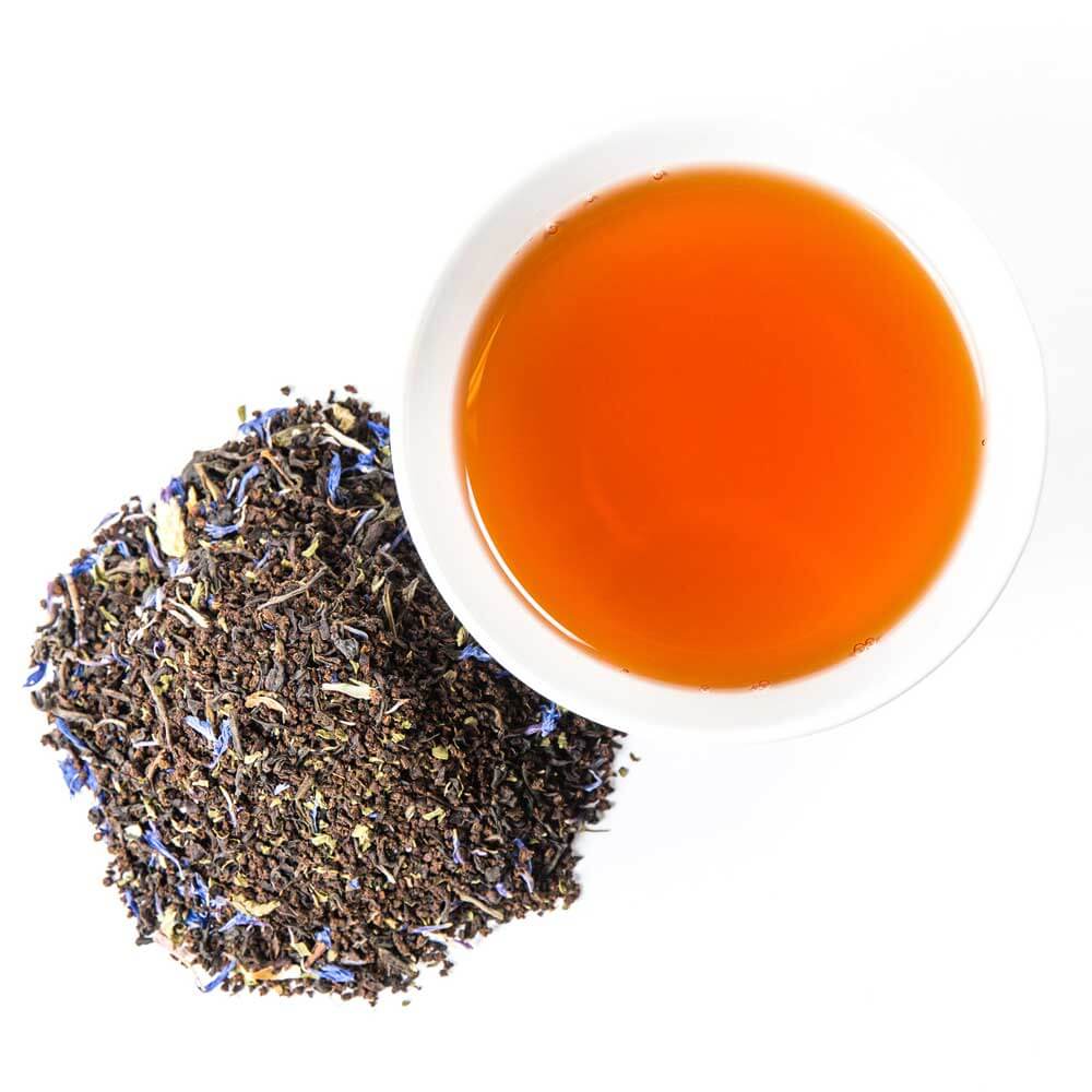 a pile of loose leaf next to a cup of brewed tea - Front Porch Special