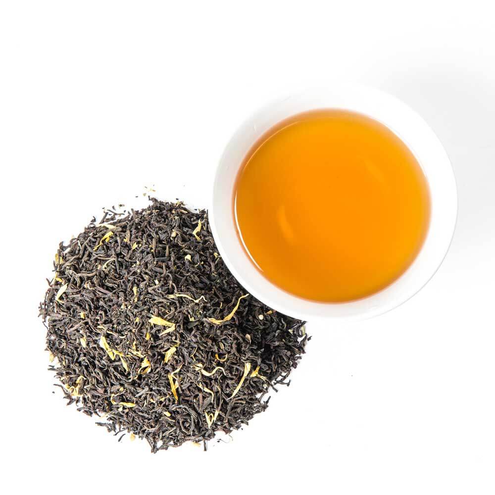 a pile of loose leaf next to a cup of brewed tea - Monks Meditation