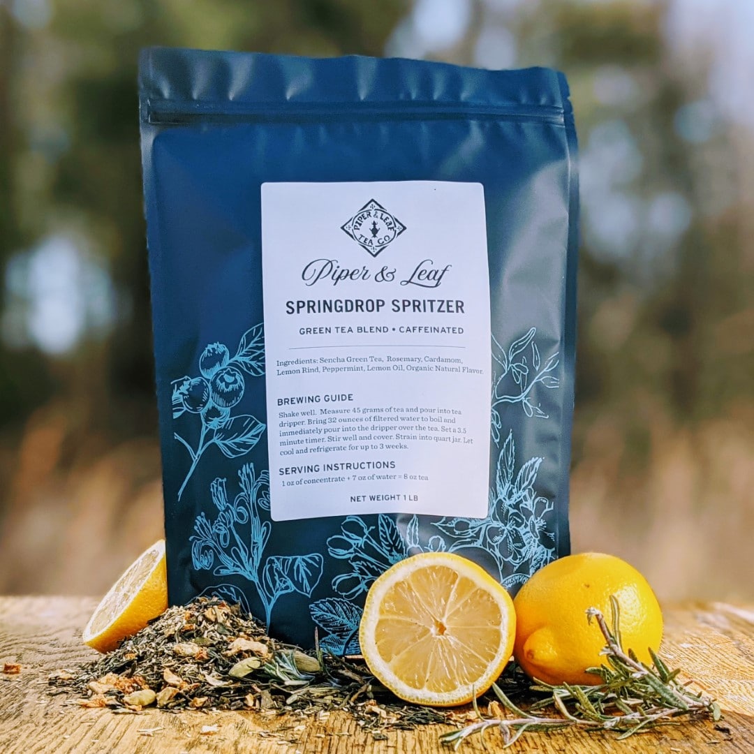 A Springdrop Spritzer Pound Bag - 190 servings of Piper & Leaf Tea Co. loose leaf green tea on a wooden table.