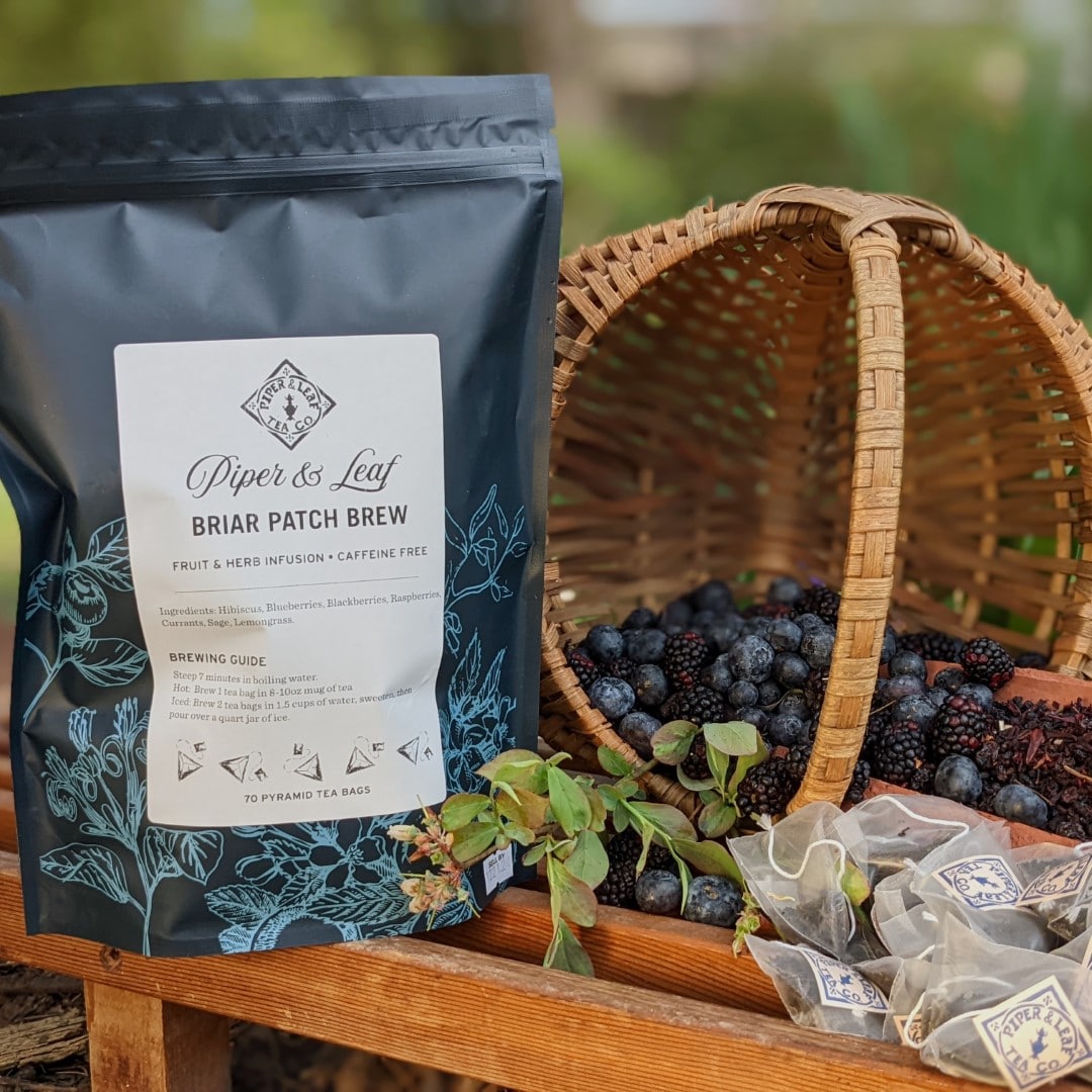 A basket of Briar Patch Brew Bulk Sachets - 70ct Tea Bags from Piper & Leaf Tea Co. and a bag of tea sachets.