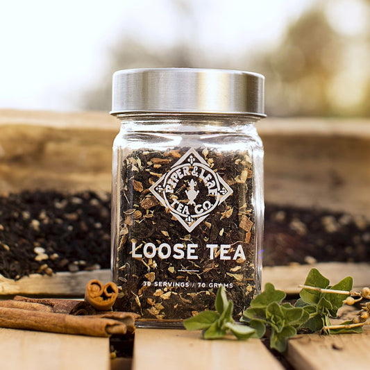 Lightly spiced Sunrise Chai Glass Jar of Loose Leaf Tea - 30 Servings by Piper & Leaf Tea Co. on a wooden table.