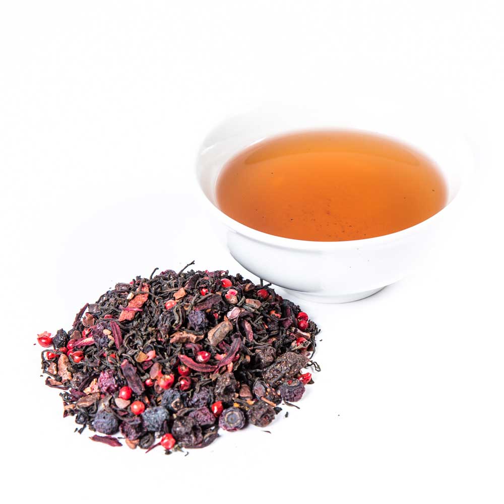 A pile of Velvet Bliss loose leaf beside a brewed cup
