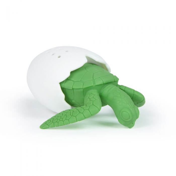 A Fred-brand tea strainer shaped like a sea turtle emerging from its egg