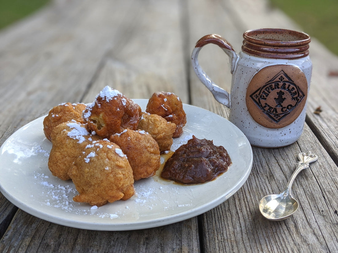Freshly made tea donuts with a side of apple butter and a hot tea (in a handmade pottery mug)
