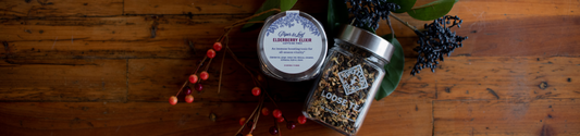Two glass jars of elderberry elixir piper and leaf herbal tea blend
