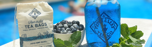 an Iced quart jar Piper Mint Blues tea sitting by a pool with Piper Mint Blues tea bags