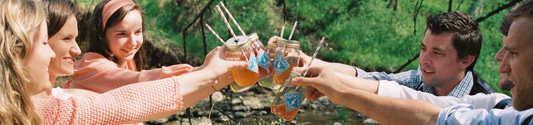 this is a picture of a Piper and Leaf Spring picnic drinking from jars of iced Piper and Leaf tea