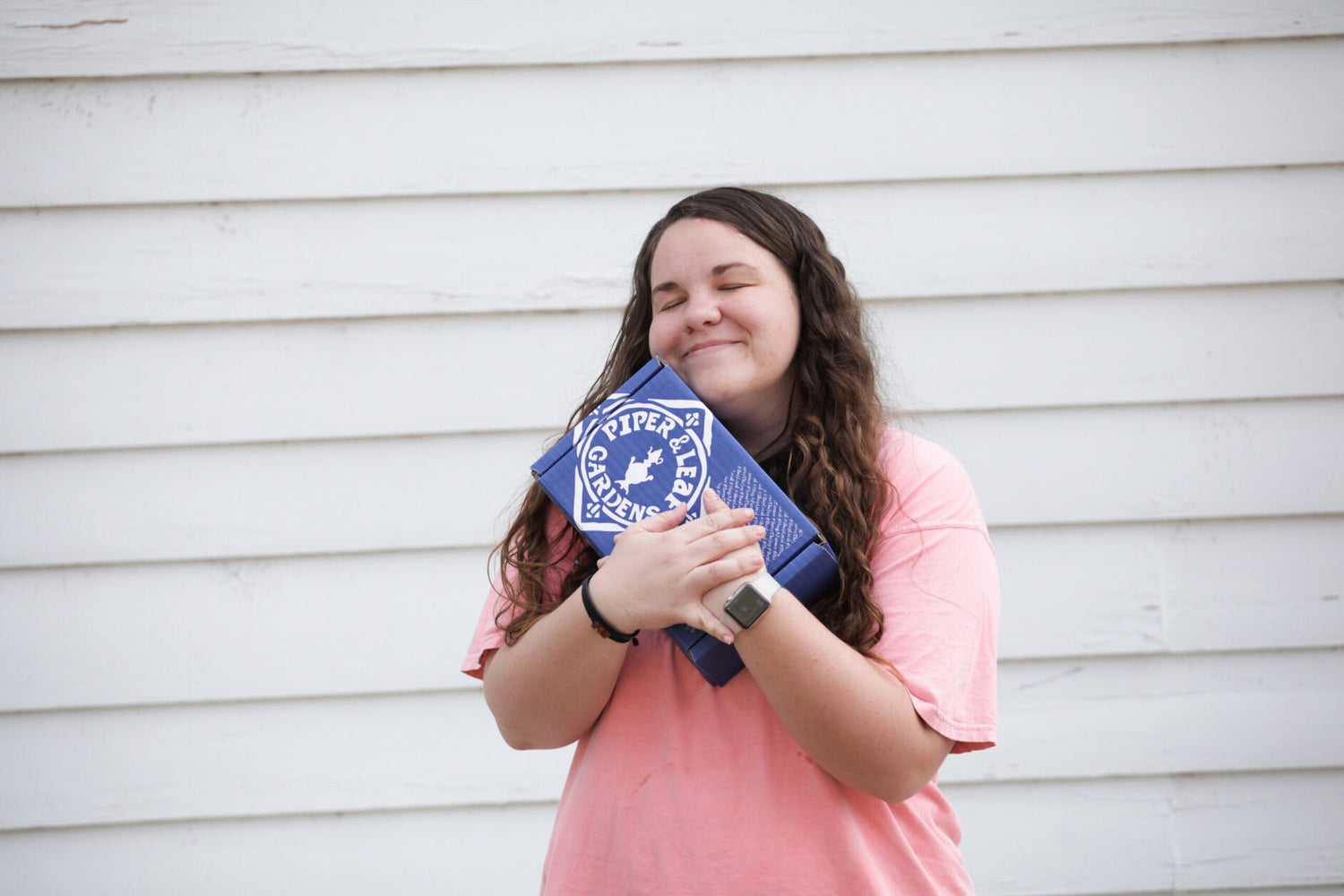 A young girl holding a blue and white polka dot bag.
