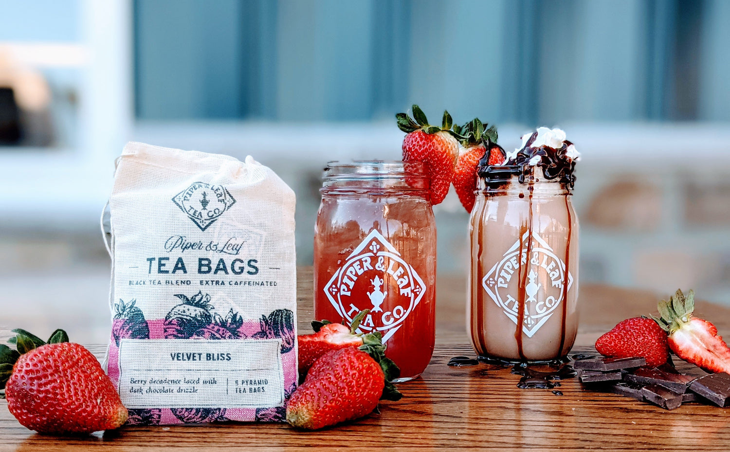 A bag of tea bags with strawberries next to it.