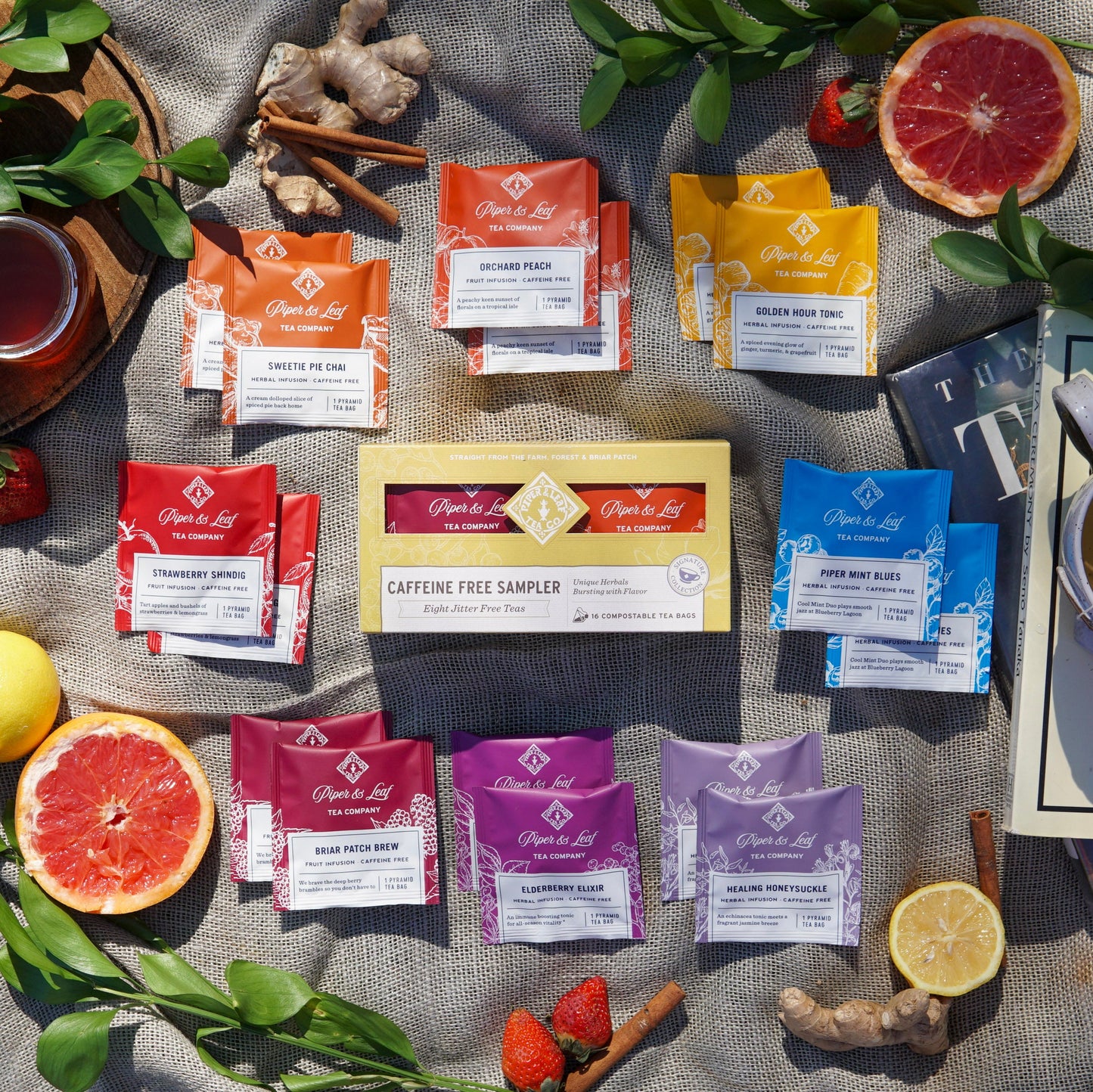 The Piper & Leaf Tea Co. Caffeine Free Sampler includes 16 individually wrapped tea bags in a sampler box, beautifully arranged with fruit and leaves—perfect for a relaxing tea tasting experience any time of day.