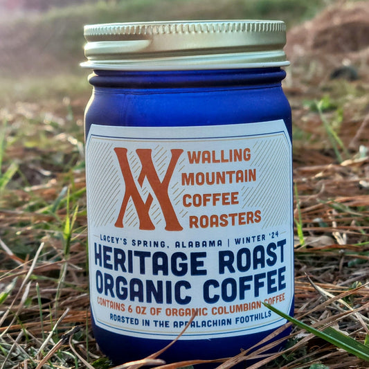 Introducing Walling Mtn. Coffee's 6oz Jar of Heritage Roast Organic Coffee, a blue jar filled with organic Colombian coffee crafted using traditional roasting and natural farming techniques. Produced by Walling Mtn. Coffee in Lacey's Spring, Alabama, for Winter '24.