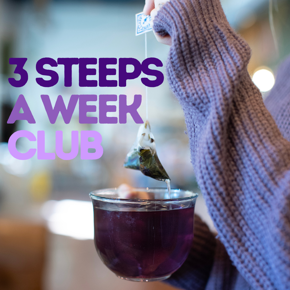 Individual holding a Piper and Leaf Tea Co. mug in purple, complete with a tea bag, accompanied by the text: "Embark on a tea journey with our Three Steeps A Week - 52 Week Renewal.