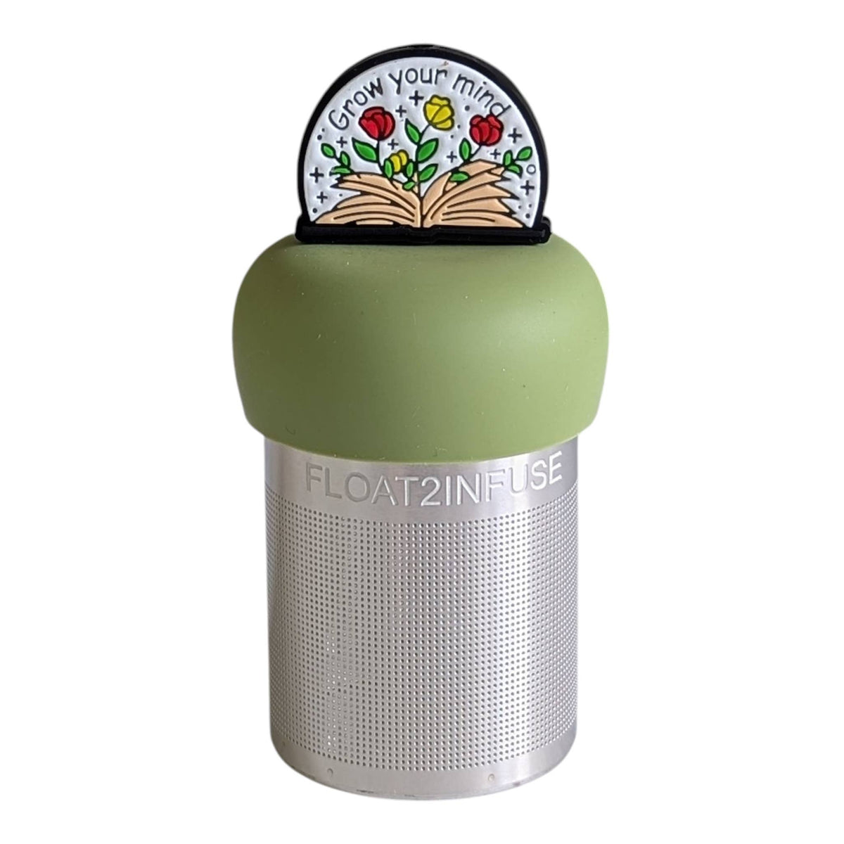 Introducing the Float2infuse Tea Infuser: Open Your Mind - Floating Tea Infuser. Featuring a metal infuser with a green silicone top and a decorative label displaying an open book with flowers and the phrase “Grow your mind,” this charming loose-leaf tea accessory is perfect for BookTok enthusiasts who want to make steeping their favorite blends easy and delightful.