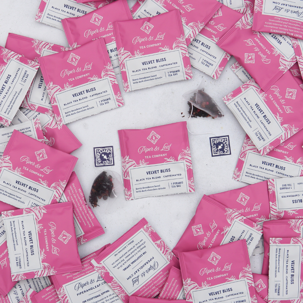 A bunch of Velvet Bliss Case of Individually Wrapped Tea Bags- 50ct on a table in the pantry from Piper & Leaf Tea Co.