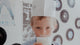 A young child in a paper hat and milk mustache stands by a wall of posters and vinyl records, next to the Piper and Leaf Tea Co. Root Brew Kit, ready to mix up sweet float creations.