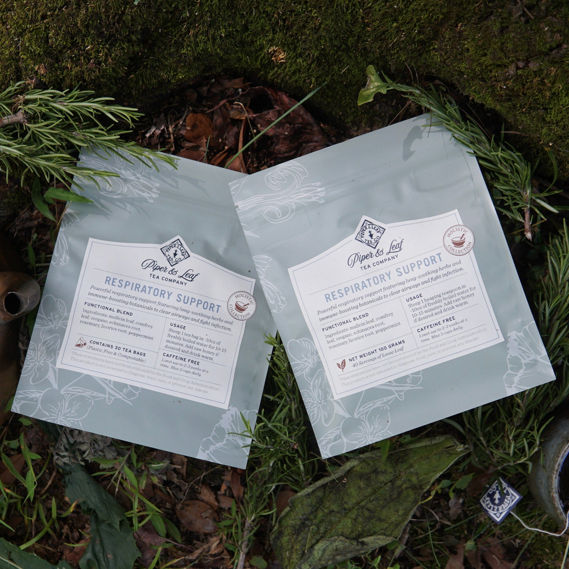 Two light blue resealable bags of Piper and Leaf Tea Co.’s “Respiratory Support” herbal tea blend are set among greenery, suggesting easy breathing and a healthy immune response with every soothing cup.