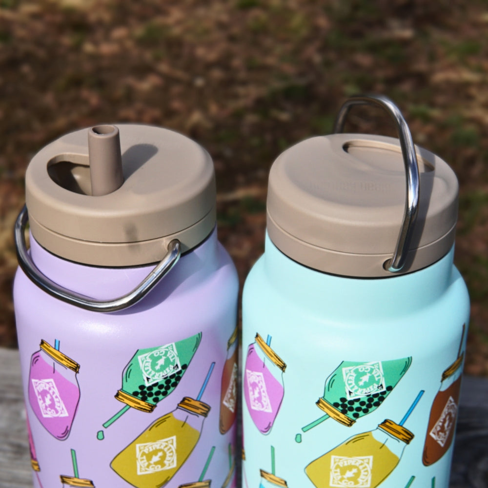 Explore our limited edition 32oz Klean Kanteens from Piper & Leaf Tea Co.: pastel purple and mint green mason jar designs with beige lids, silver handles, straws, and BPA-free double-walled vacuum insulation for ultimate refreshment.