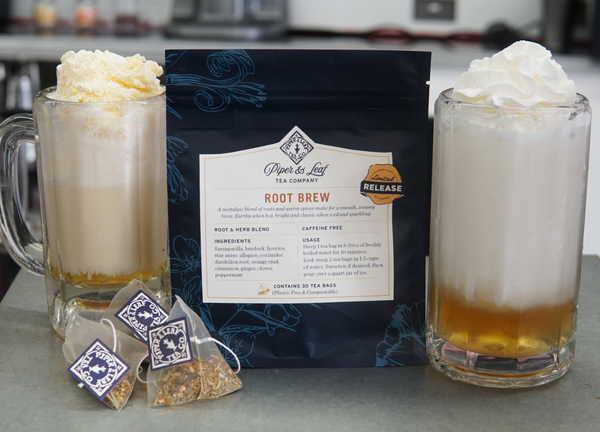 Two frothy glasses of Root Brew sit beside a bag of Piper and Leaf Tea Co. Root Brew loose tea and two tea bags, highlighting the creamy flavors and nostalgic spices of this unique blend.