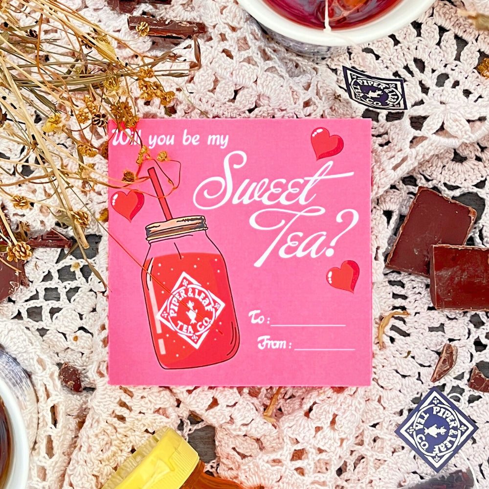 Piper & Leaf Tea Co.'s "Tea Valentines" card features "Will you be my sweet tea?" with hearts and a jar, amidst dried flowers and chocolates. Ideal for Valentine's Day, it complements your berry best blends or build your own tea bundle.