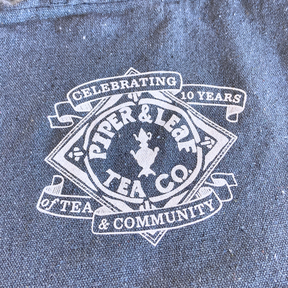 upclose of the 10 year anniversary logo that is screen printed onto our newest tote bag!