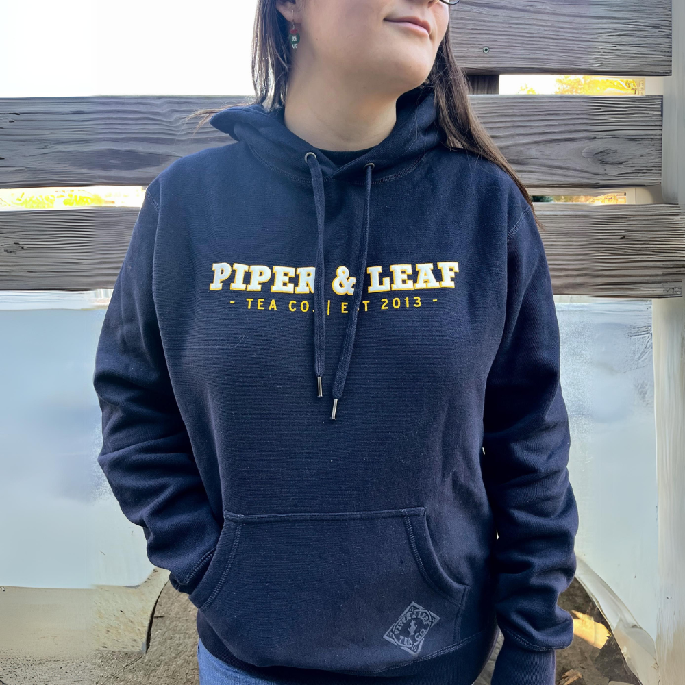 A woman wearing The Legacy - P&L Collegiate Sweatshirt Hoodie by Piper & Leaf Tea Co.