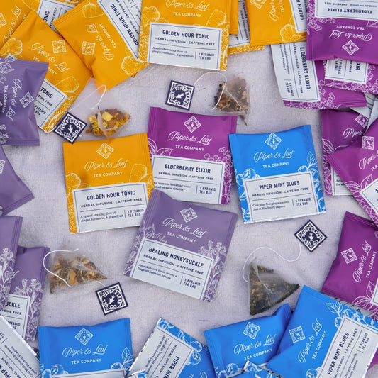 Enhance your caffeine-free herbal tea collection with Piper & Leaf Tea Co.'s Wellness Blends - 50ct Tea Bags, featuring invigorating flavors like Golden Hour Tonic, Elderberry Elixir, Healing Honeysuckle, and Piper Mint Blues. Perfect for any tea enthusiast's stash.