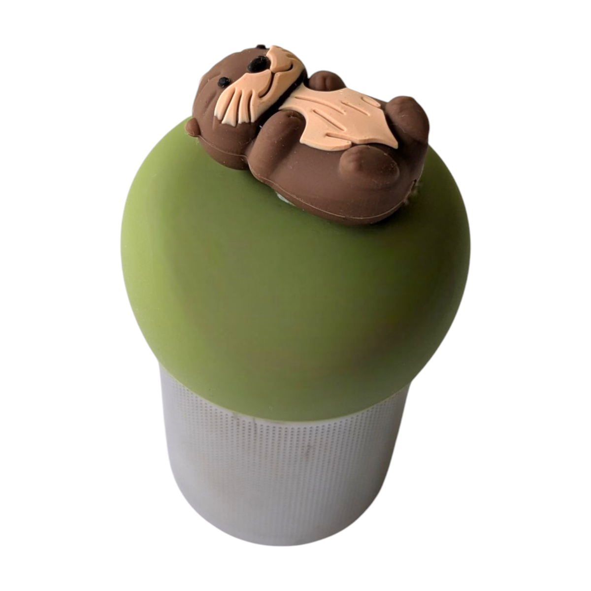A green-lidded container featuring a brown otter figurine lying on top serves as the Float2infuse Tea Infuser’s “Otter - Floating Tea Infuser,” a charming accessory designed for storing loose leaf tea, shown isolated on a white background.