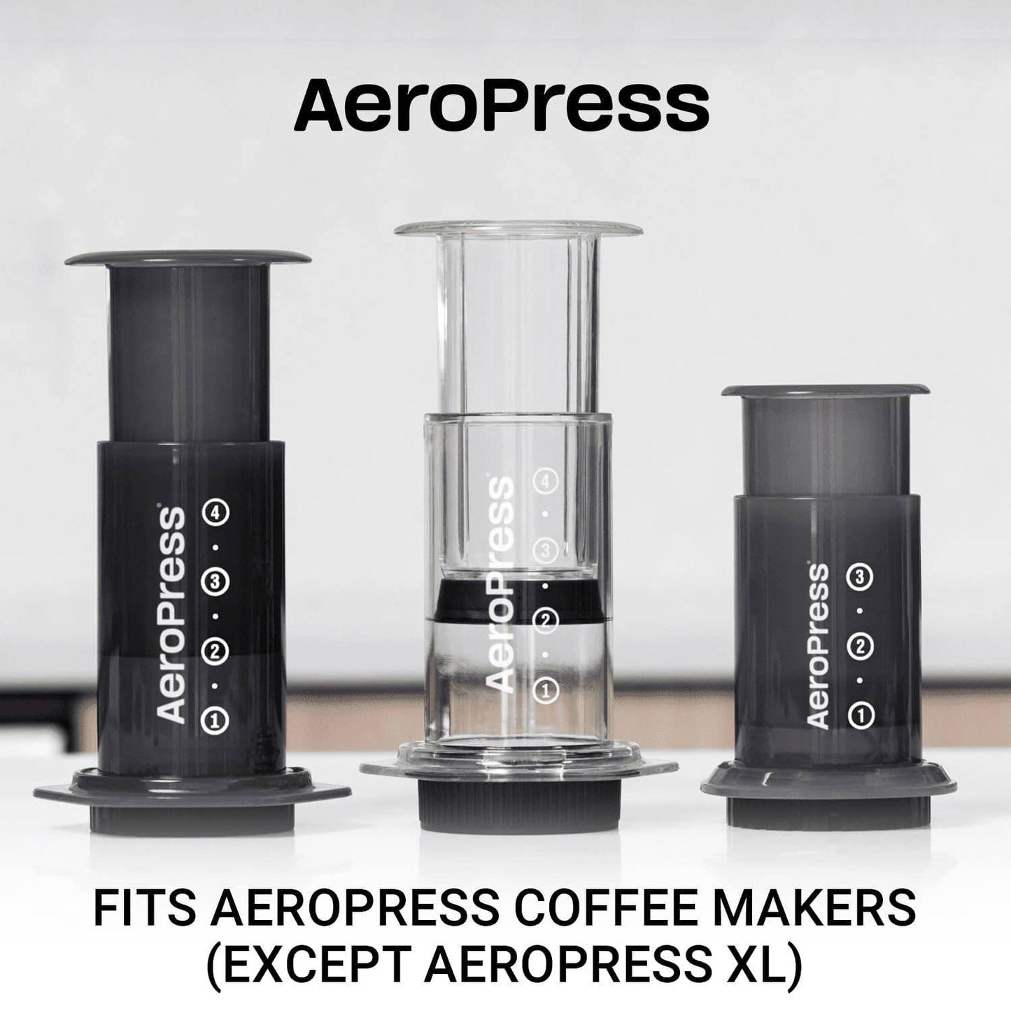 Three AeroPress coffee makers of various sizes are shown side by side on a white surface with text below: "Fits AeroPress Coffee Makers (Except AeroPress XL)," highlighting that the AeroPress Paper Micro-Filters are compatible replacement filters.