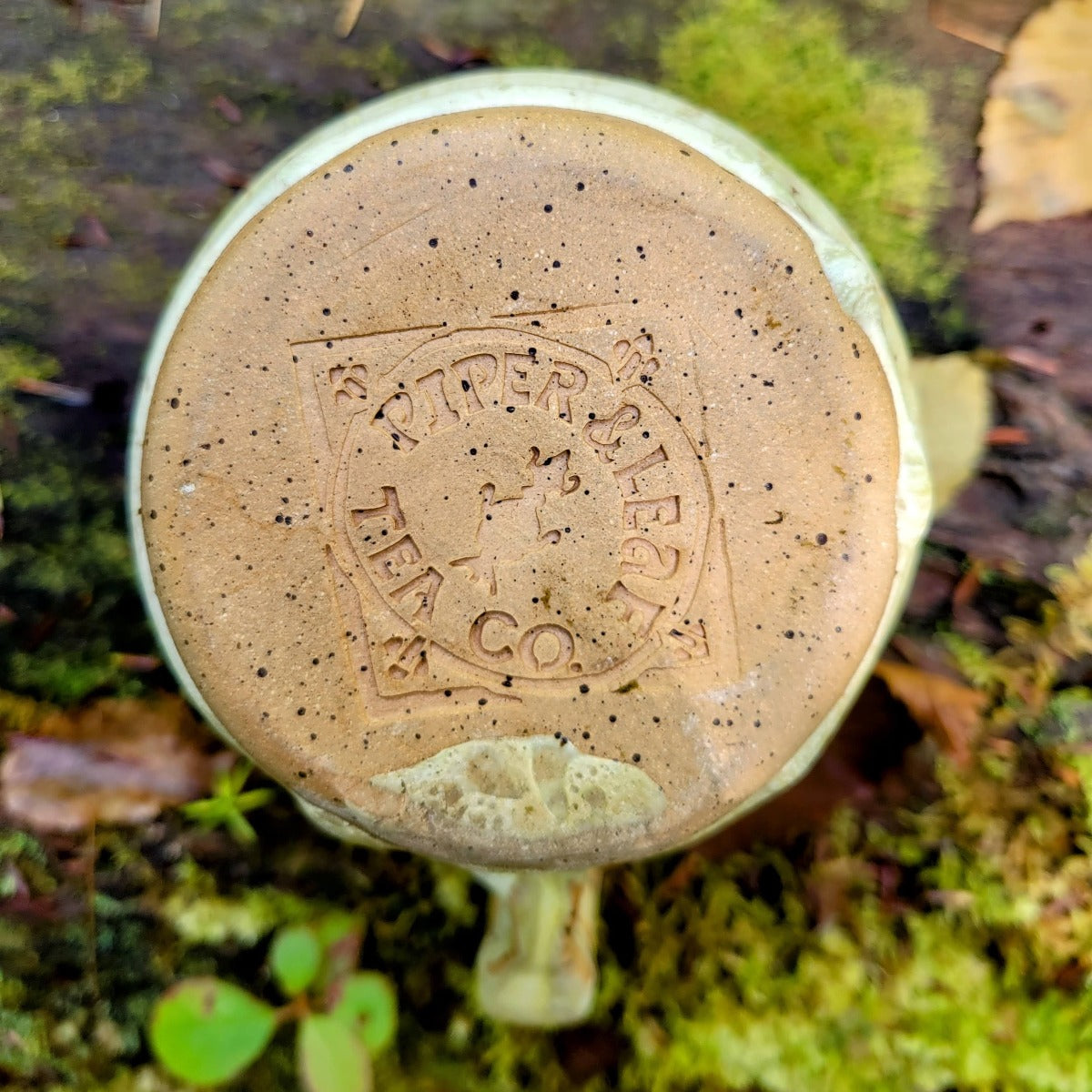 Bottom look at the handmade pottery mug "HOT-TEA" with Piper & Leaf diamond logo
