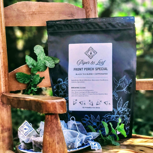 A Front Porch Special Bulk Sachets - 70ct Tea Bags from Piper & Leaf Tea Co. sitting on a wooden chair.