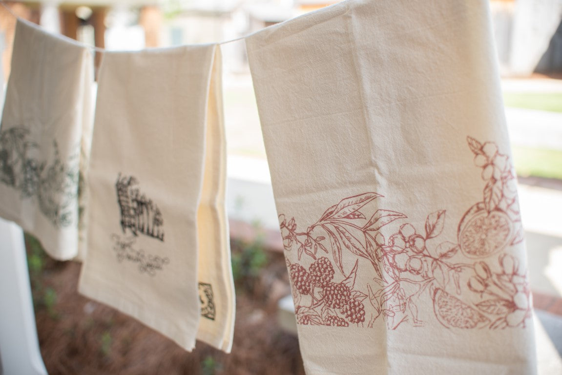 Garden Tea Party Tea Towel handing on a clothes line with the Front Porch Special