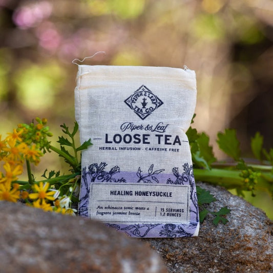 Healing Honeysuckle Muslin Bag of Loose Leaf Tea - 15 Servings in a bag on a rock. (Piper & Leaf Tea Co.)