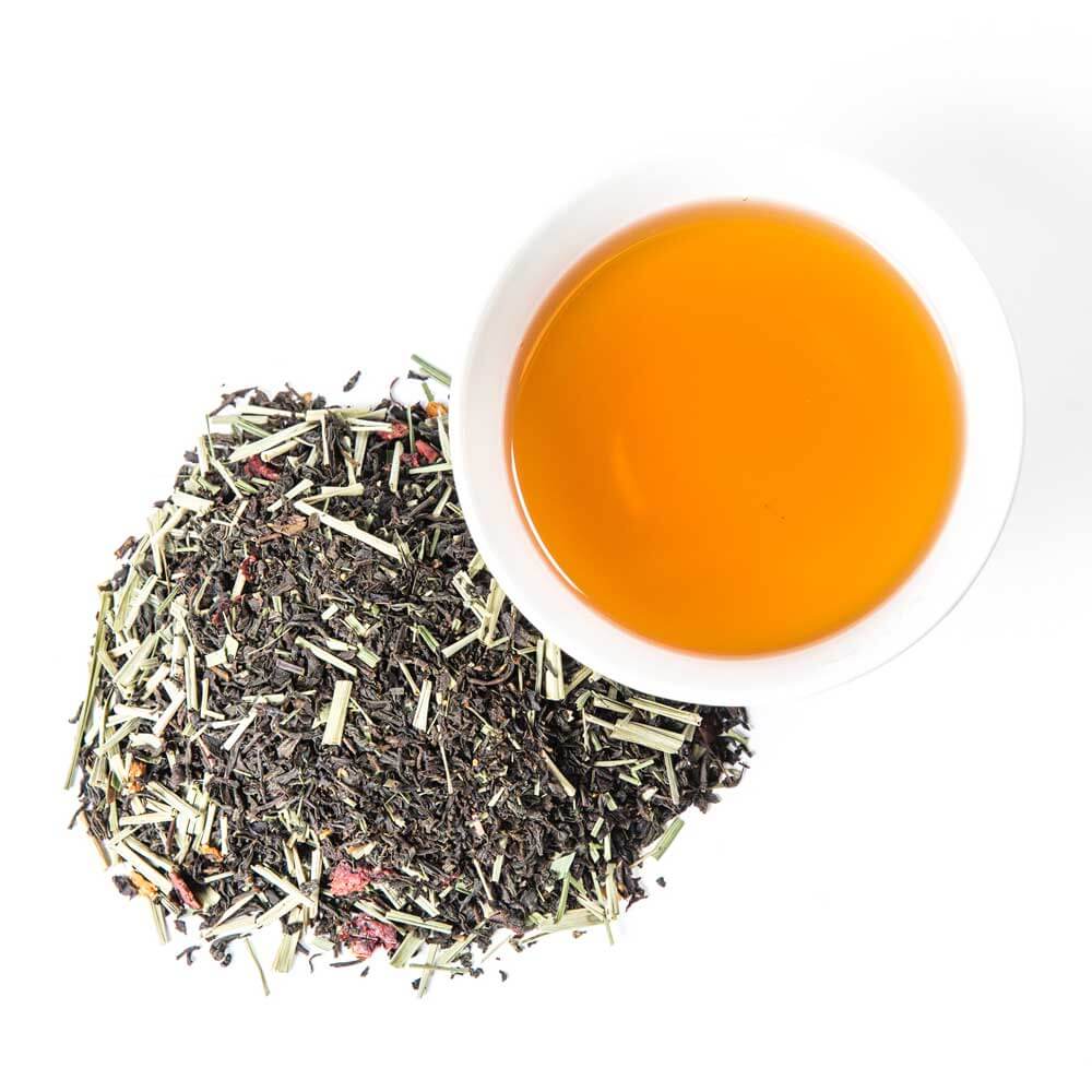 a pile of loose leaf next to a cup of brewed tea - Lemon Berry Blush