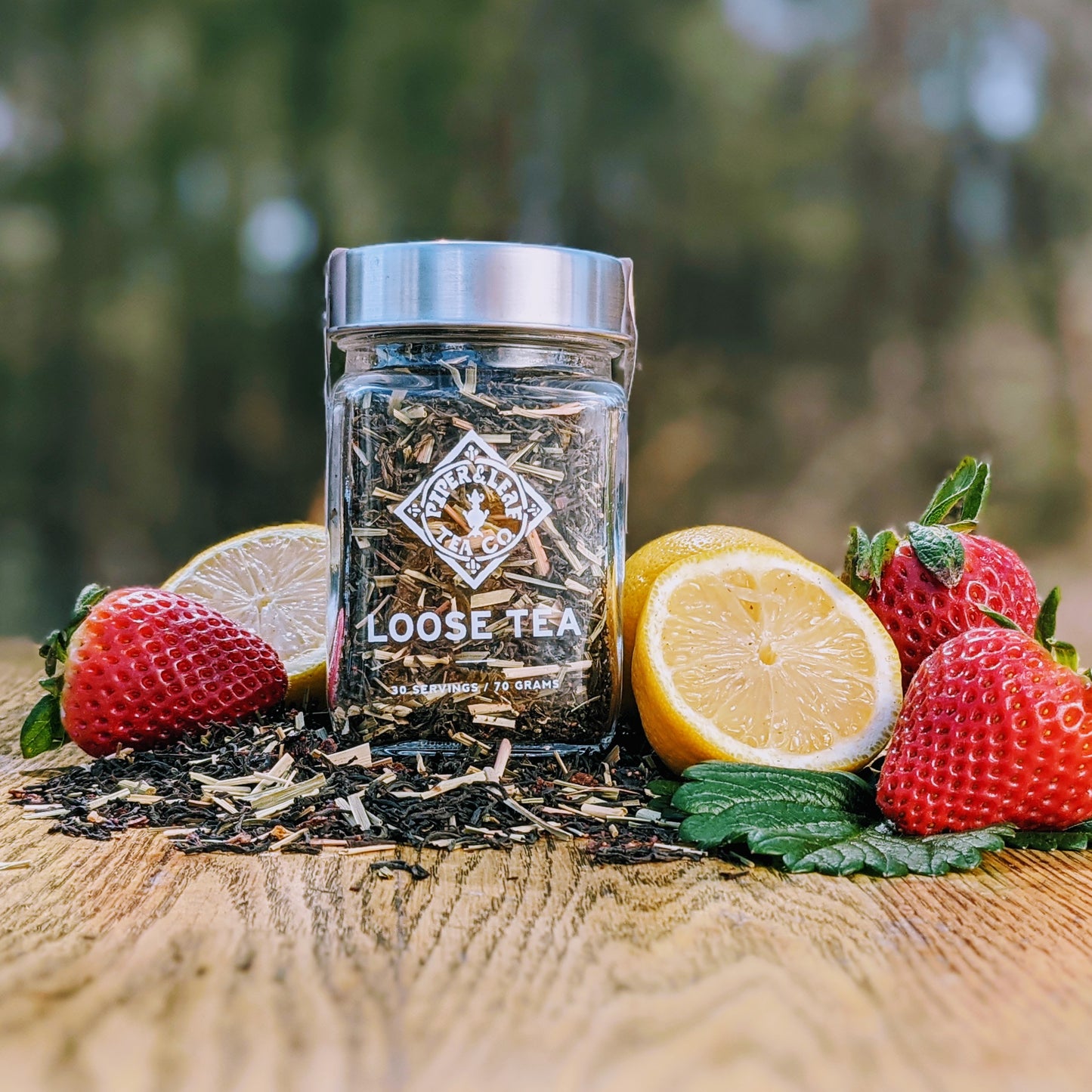A refreshing Lemon Berry Blush Glass Jar of flavored tea with citrus-infused lemons and strawberries from Piper & Leaf Tea Co.