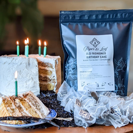 A cake with candles and a bag of Old Fashioned Birthday Cake Bulk Sachets - 70ct Tea Bags from Piper & Leaf Tea Co.