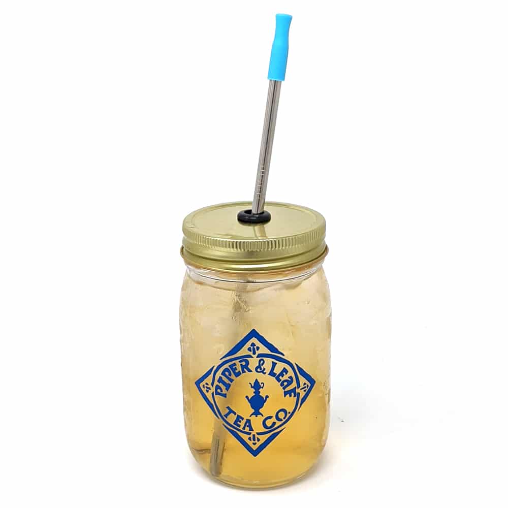 A Piper & Leaf pint jar with a blue logo and a reusable metal straw