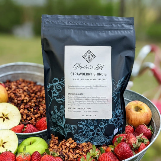 A basket full of tart apples and a bag of Strawberry Shindig Pound Bag - 190 servings from Piper & Leaf Tea Co.