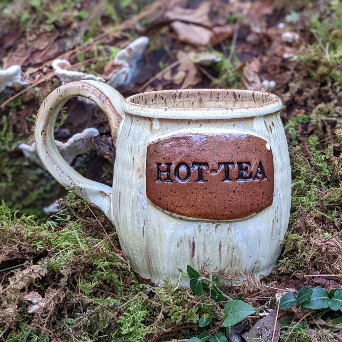 Handmade pottery mug with HOT-TEA on the front