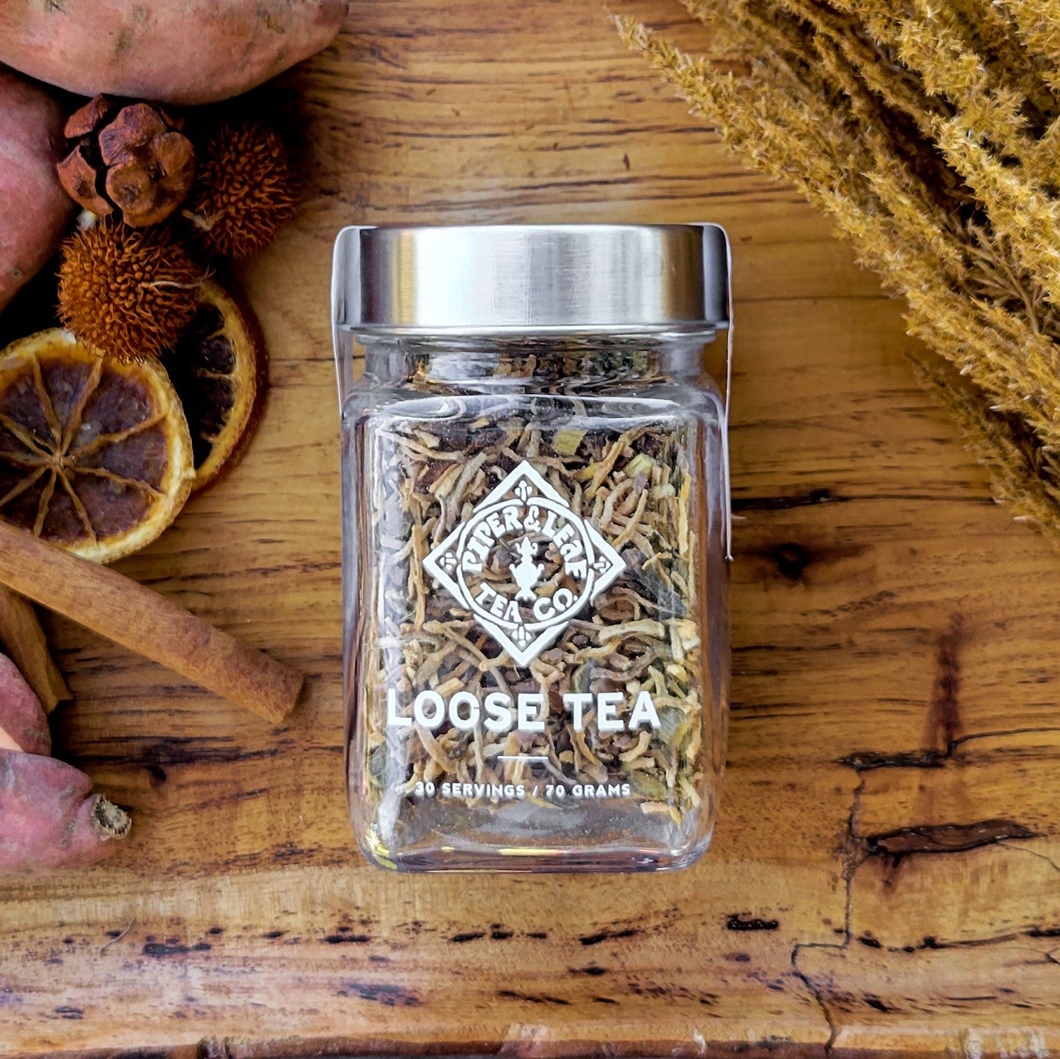 A Sweetie Pie Chai Glass Jar of Loose Leaf Tea - 30 Servings by Piper & Leaf Tea Co. on a wooden table.